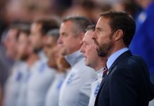 Gareth Southgate of England sings the National Anthem with his coaching staff ahead of the International Friendly match