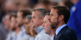 Gareth Southgate of England sings the National Anthem with his coaching staff ahead of the International Friendly match