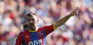 James McArthur of Crystal Palace shouts orders to his team mates as it looks like he is missing his front teeth after a previous challenge