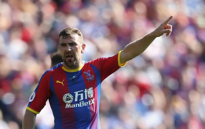 James McArthur of Crystal Palace shouts orders to his team mates as it looks like he is missing his front teeth after a previous challenge