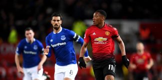Anthony Martial of Manchester United runs with the ball alongside Andre Gomes of Everton