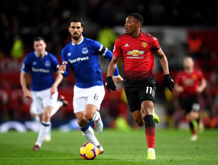 Anthony Martial of Manchester United runs with the ball alongside Andre Gomes of Everton