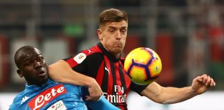 Kalidou Koulibaly of SSC Napoli competes for the ball with Krzysztof Piatek of AC Milan