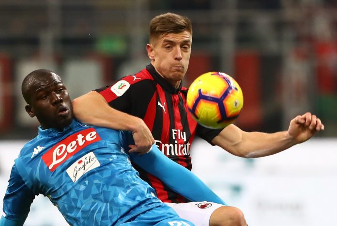 Kalidou Koulibaly of SSC Napoli competes for the ball with Krzysztof Piatek of AC Milan