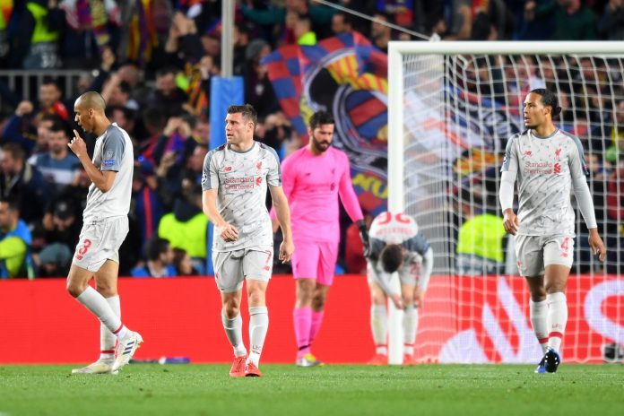 Liverpool look on dejected after Lionel Messi of Barcelona (not pictured) scores his sides second goal during the UEFA Champions League Semi Final first leg