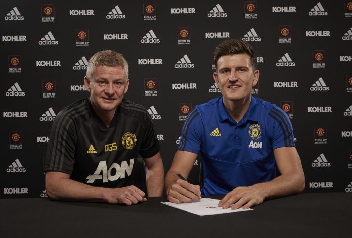 Harry Maguire of Manchester United poses with Manager Ole Gunnar Solskjaer after signing for the club