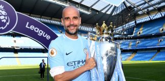Pep Guardiola, Manager of Manchester City poses with The Premier League Trophy