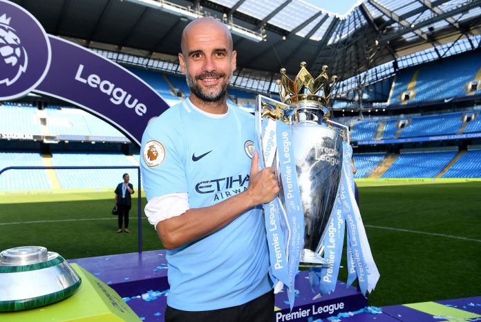 Pep Guardiola, Manager of Manchester City poses with The Premier League Trophy