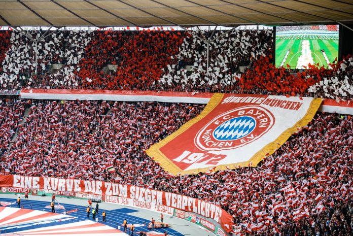 Fans of Bayern Munich show their logo prior to the DFB Cup final between RB Leipzig and Bayern Munchen at Olympiastadion