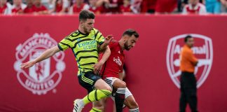 Arsenal midfielder Declan Rice and Manchester United captain Bruno Fernandes fight for the ball during an friendly game.